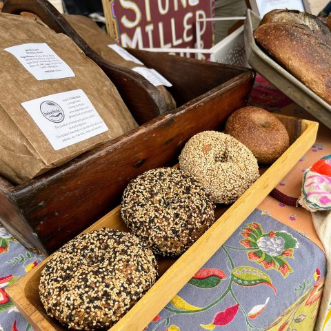fresh bagels and bread displayed on a table