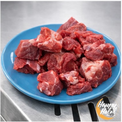 A blue plate with cubes of uncooked lamb meat.