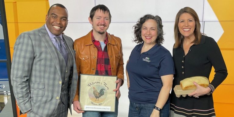 two men and two women smile for camera