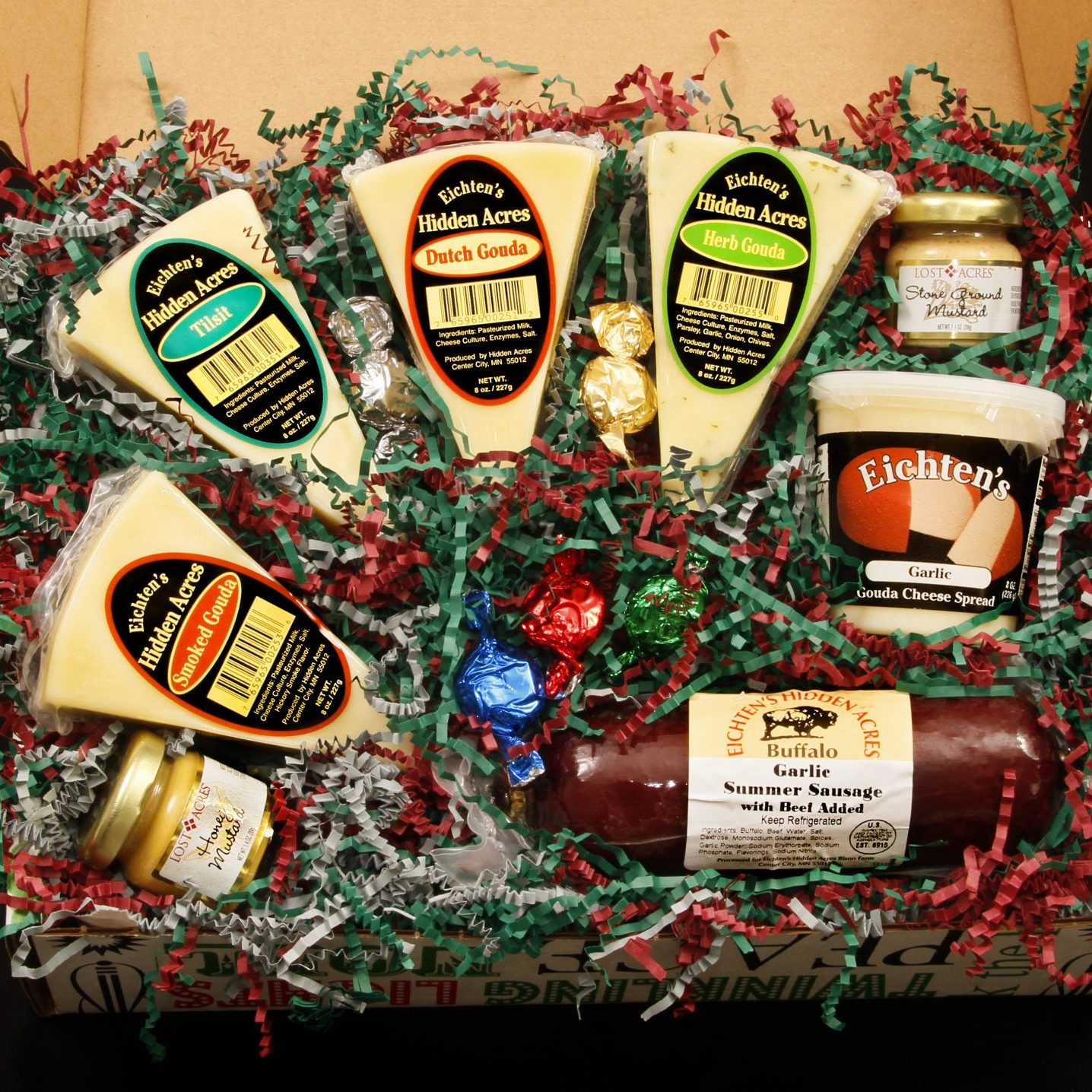 gift box filled with cheese and sausage, background of crinkle paper