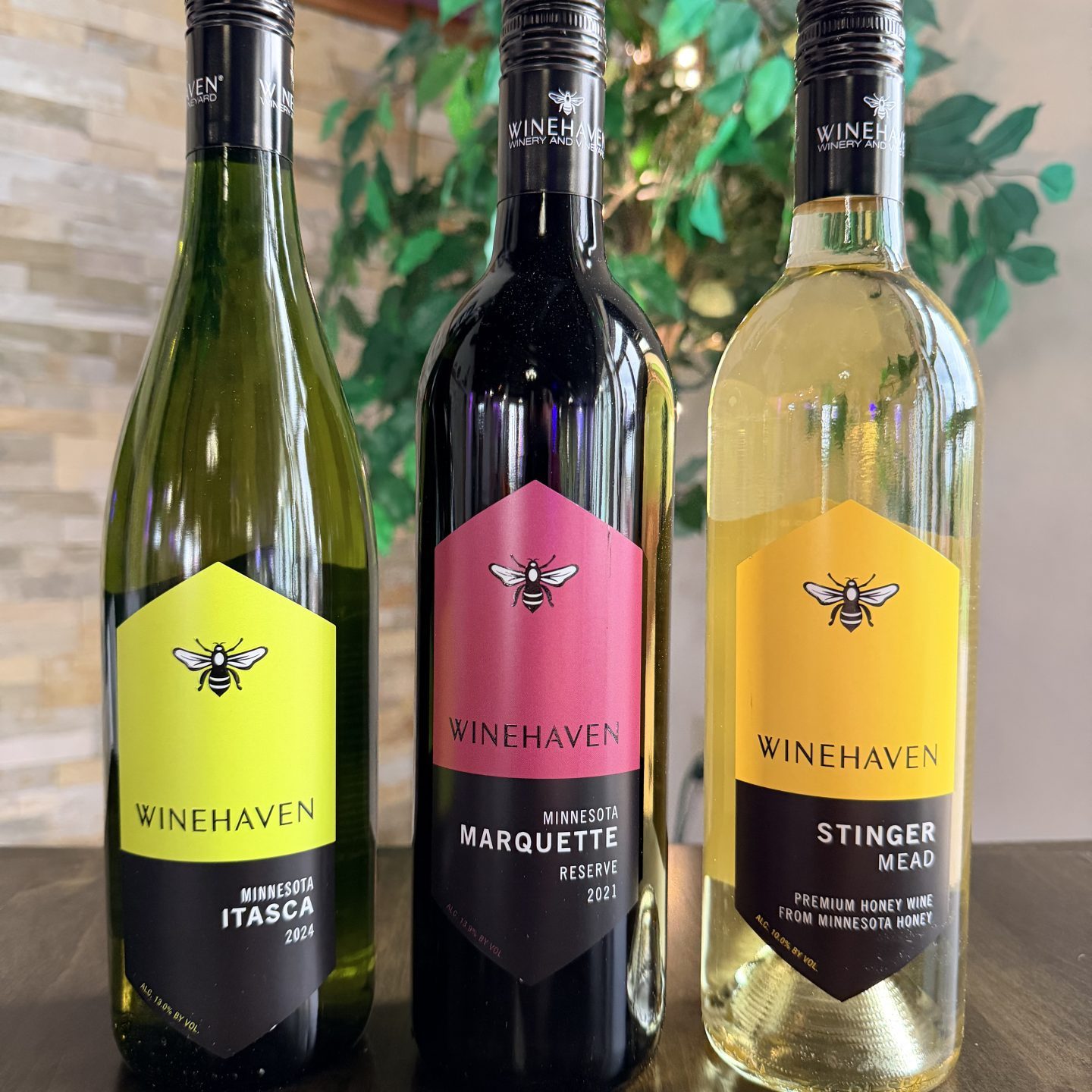 thee wine bottles on a table