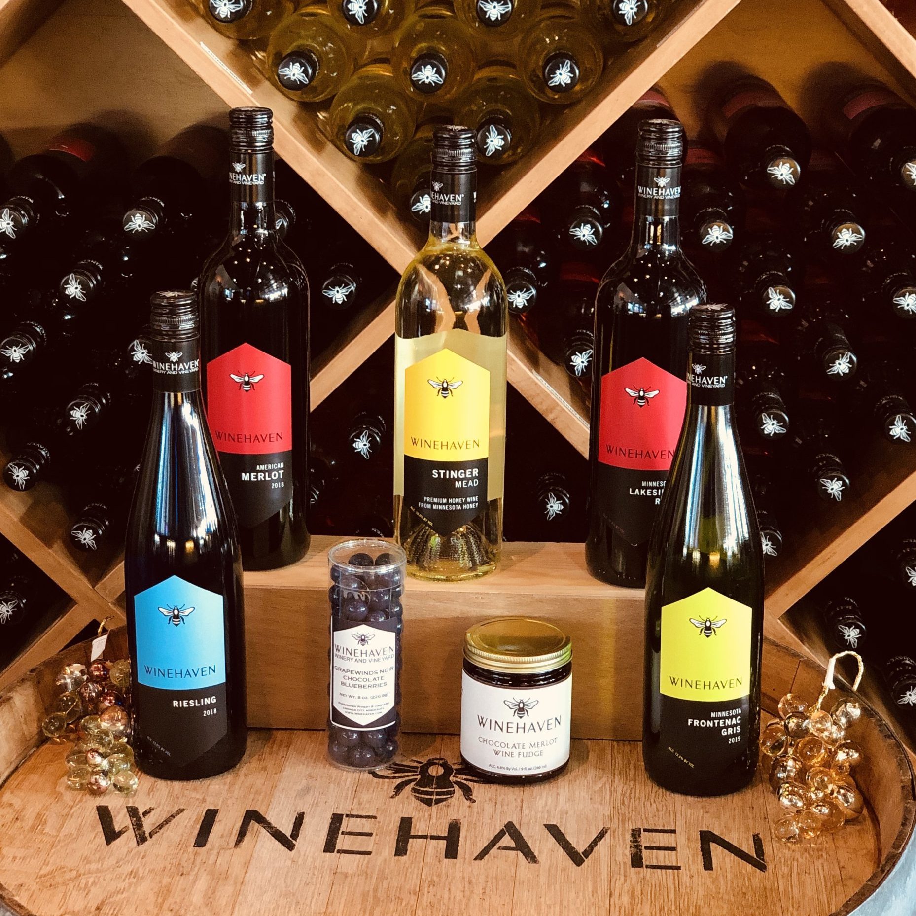 5 wines, a tube of candy, and a jar of chocolate sit behind the words WINEHAVEN