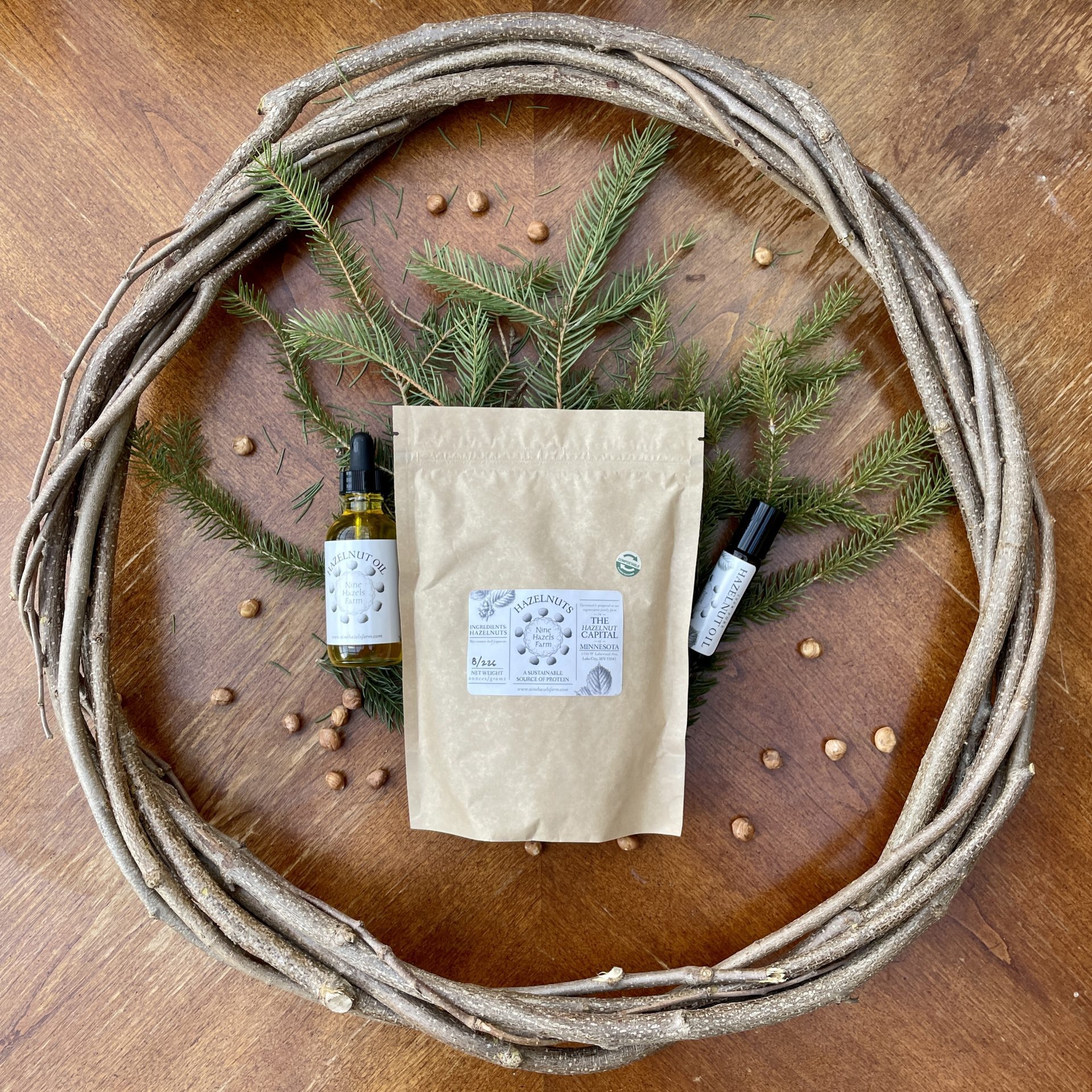 hazel wood weasr around pine branches tincture bottle, bag, and a lip balm