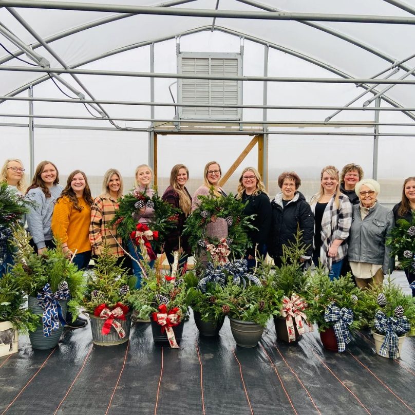 lots of women in a green house all with their own decorated porch pot