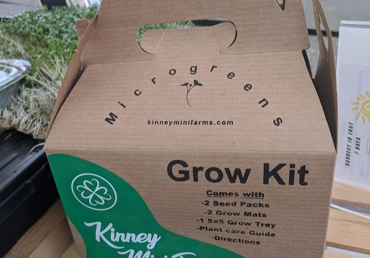 A cardboad box with a handle and the text: Grow Kit